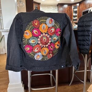 Boho embroidered denim jacket with vibrant colors.